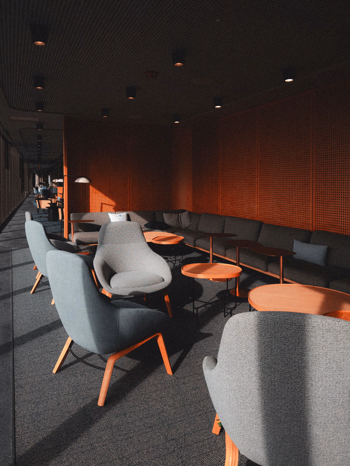 Licensed stock: moody coworking lounge with gray chairs and soft daylight — illustrative, no named space.